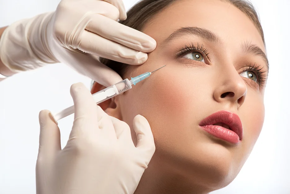 Practitioner giving an injection near a client's eye area