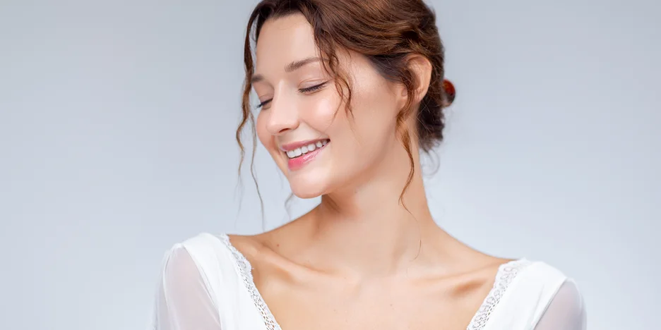Smiling woman with healthy, even-toned skin