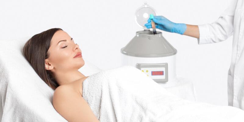 Cosmetologist does prp therapy on the face of a woman