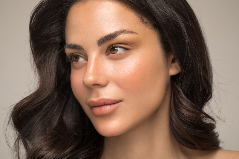 Stunning studio shot of a gorgeous woman with freckles.