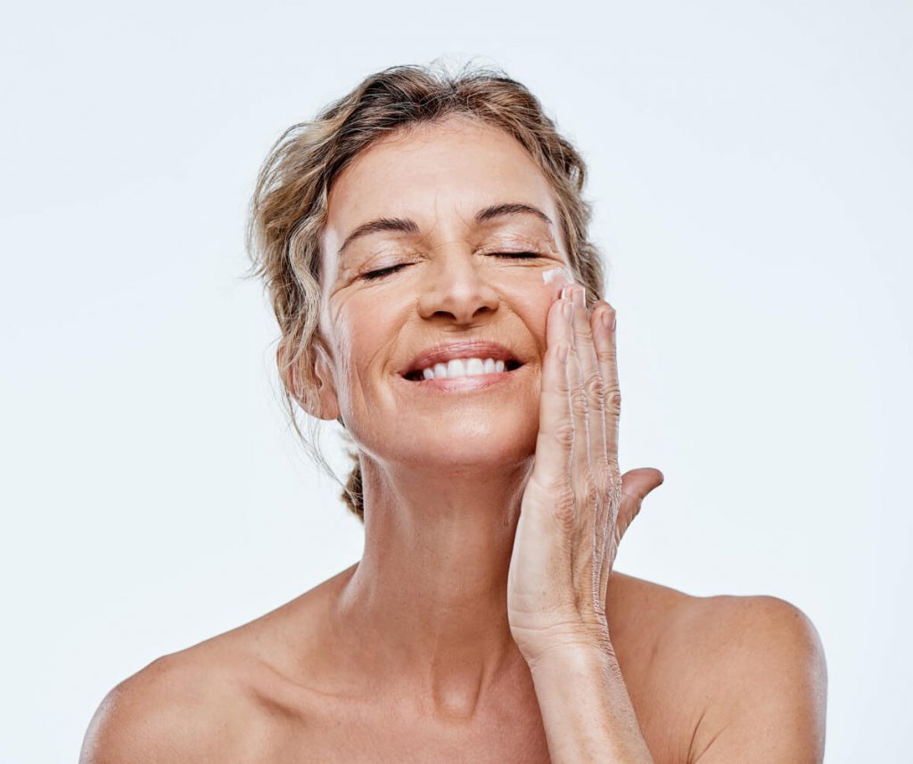 Shot of a mature woman posing with moisturiser on her face