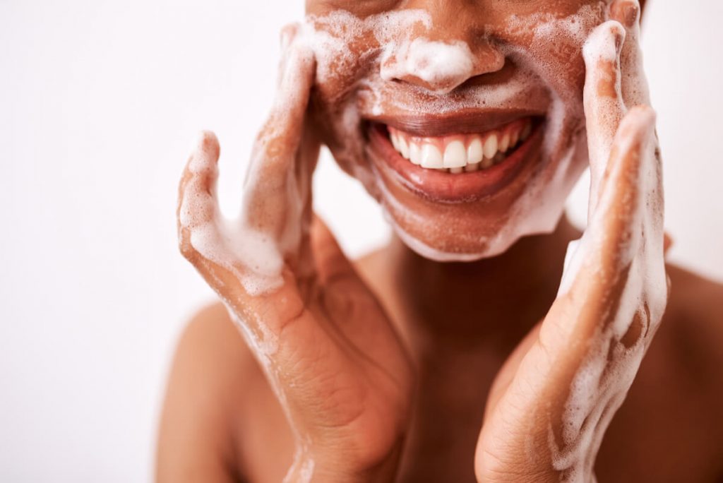 unrecognizable woman washing her face