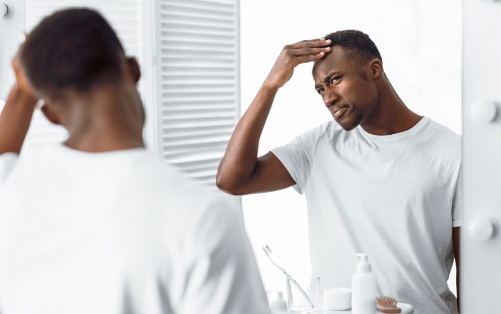 Black Guy Examining His Head