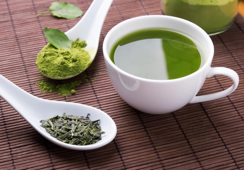 Green tea on the brown mat close-up