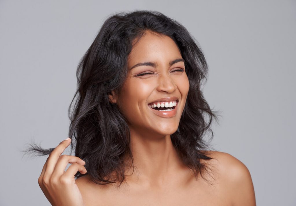 Shot of a beautiful young woman standing with her eyes closed