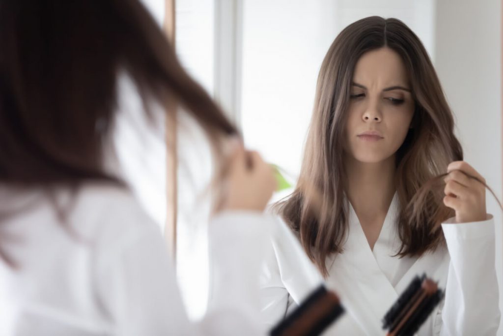 Worried girl concerned about hair loss