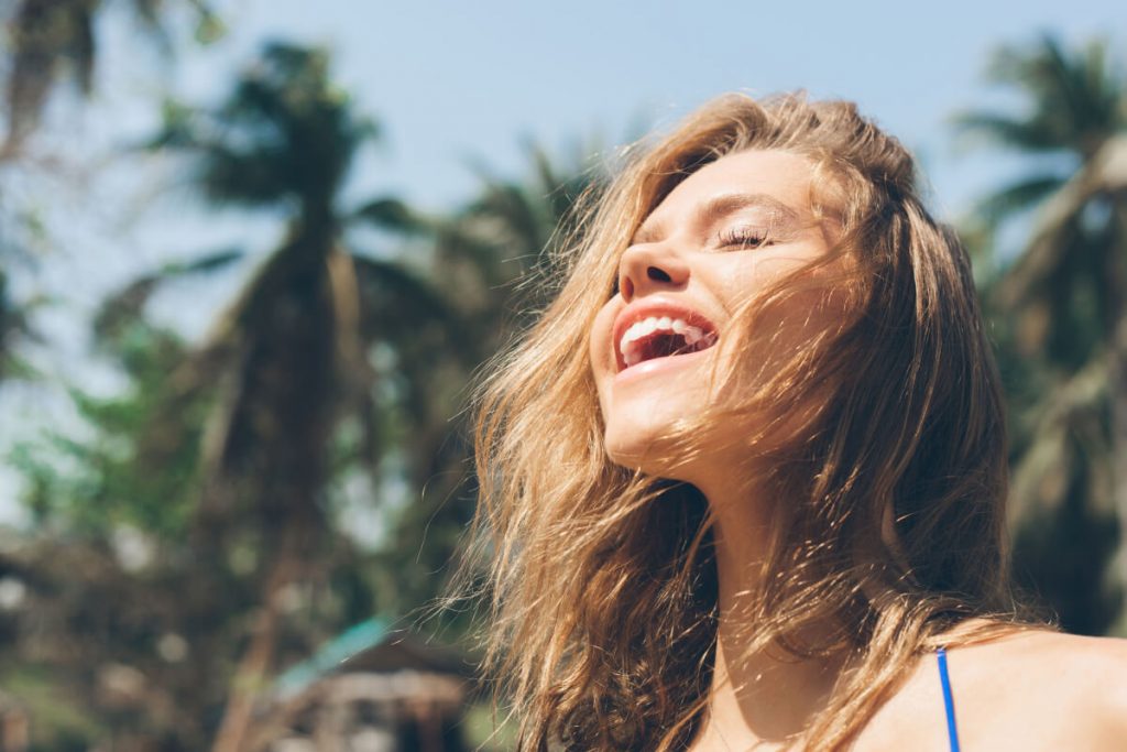 Pretty happy woman enjoying summer outdoors