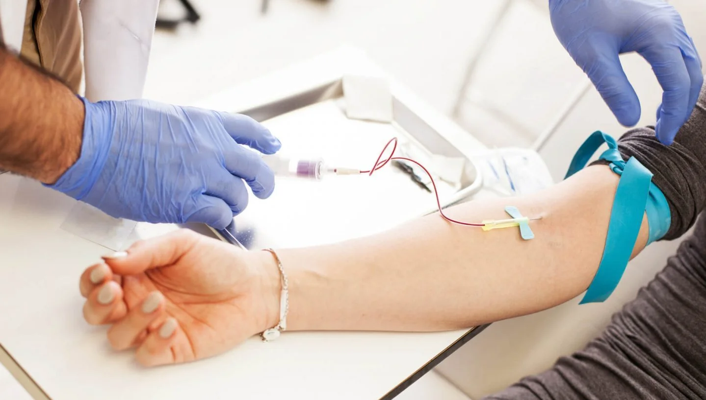 medical provider draws blood for prp treatment