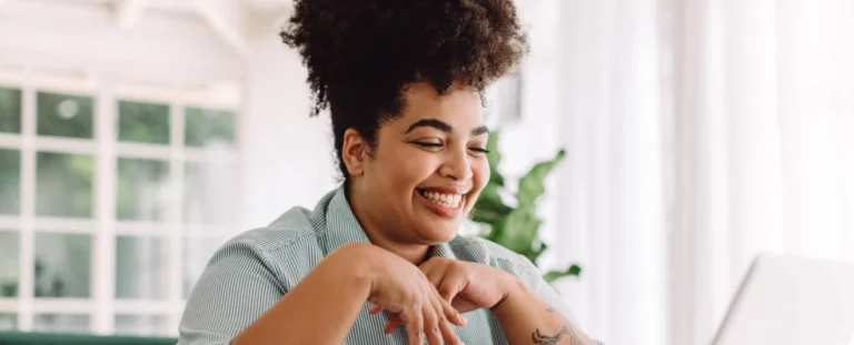 Positive woman using laptop