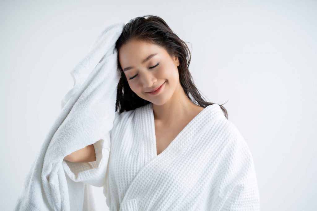 Asian women are using a dry towel to dry their hair