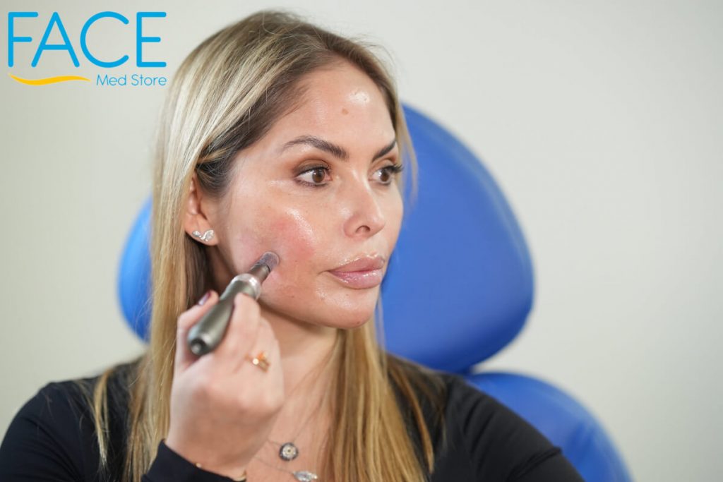 Woman doing microneedling to her face