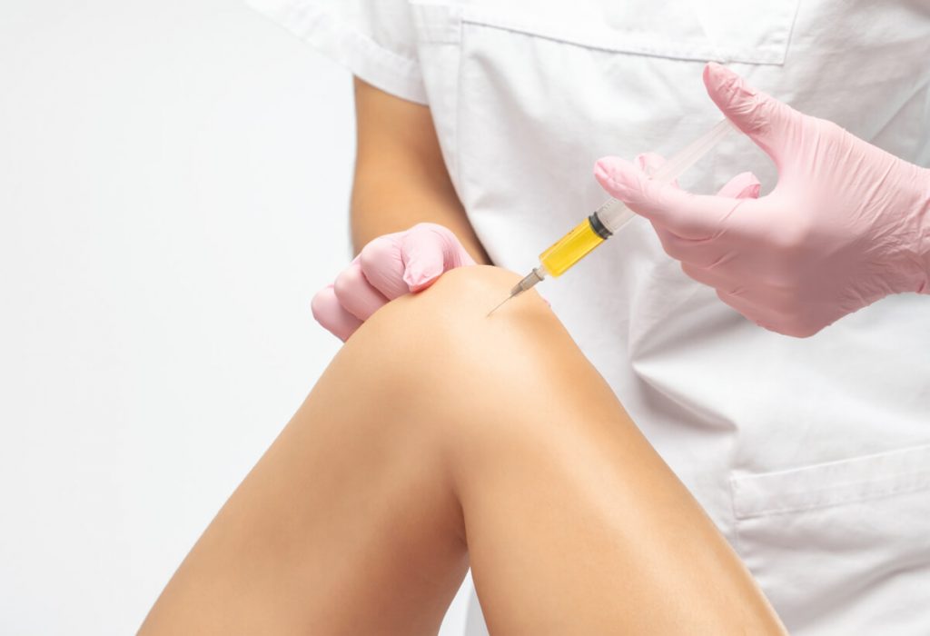 Doctor doing PRP therapy on a patient's knee after the injury