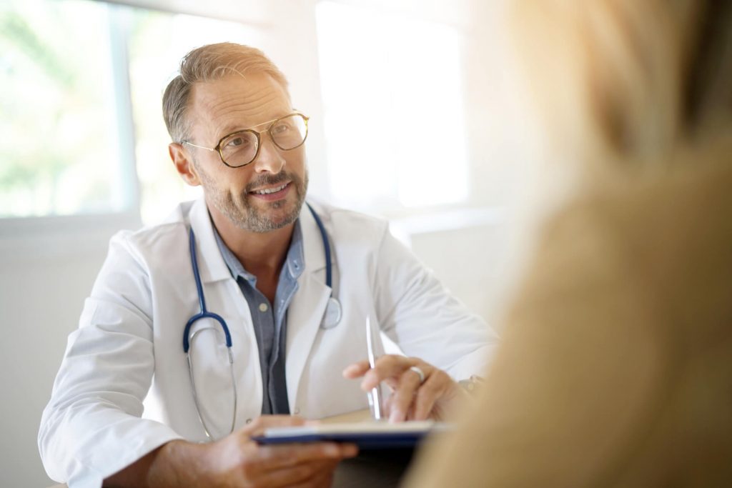 Doctor with patient in medical office