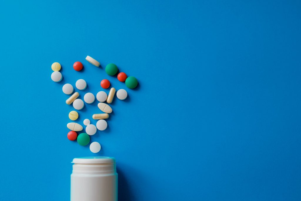 Heap of pills on blue background