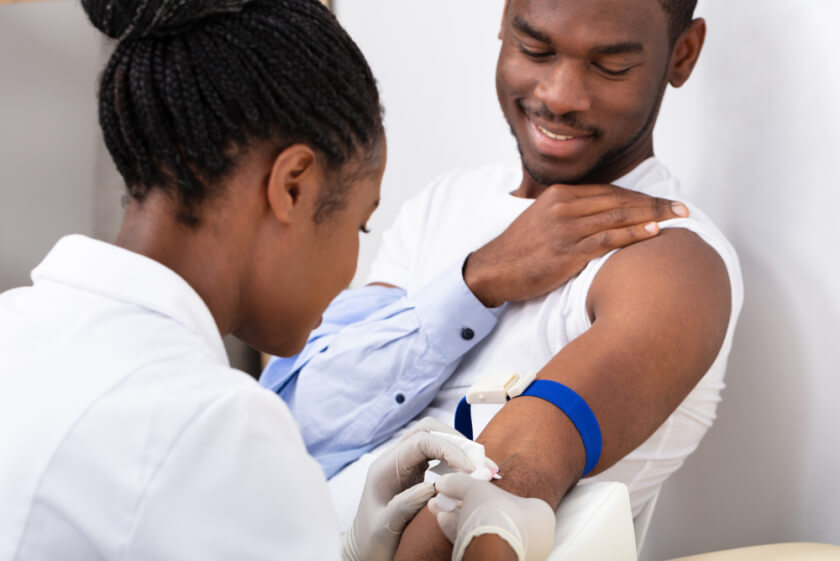 Close-up Of Female Doctor Injecting Male Patient With Syringe To Collect Blood Sample for prp hair treatment