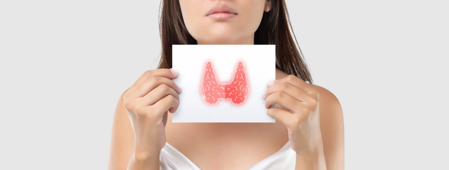 Illustration of the thyroid in the white paper is on the woman's neck