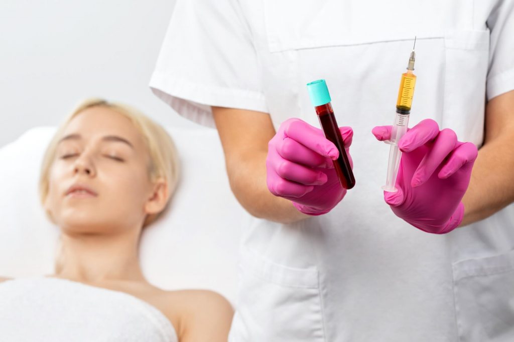 blood plasma for injections and a syringe with plasma in her test tube