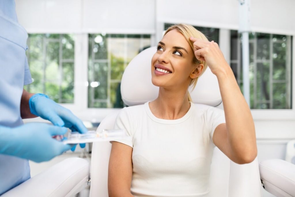 happy blonde woman at beauty medical clinic