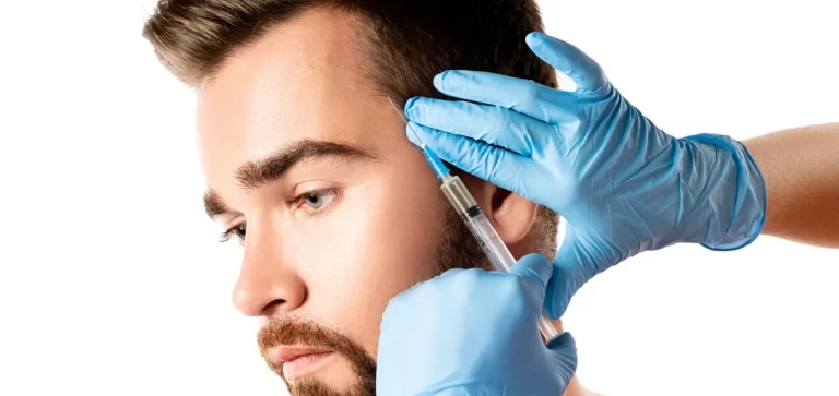 Young and handsome man receiving prp injection for hair growth