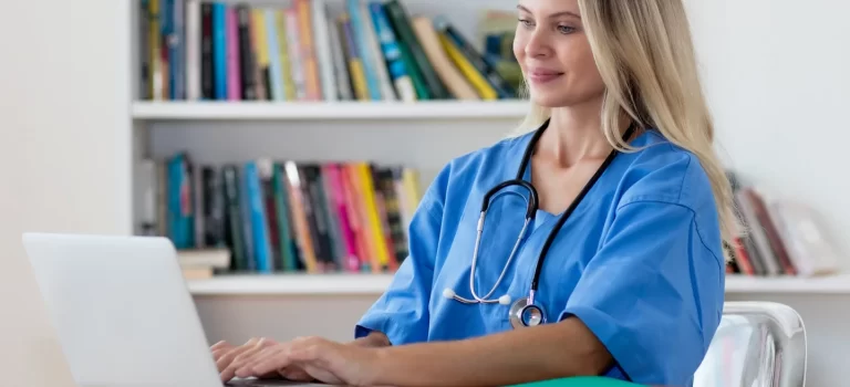Nurse in front of a computer attending online training