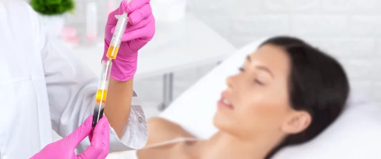 Cosmetologist preparing prp treatment for young woman in the background
