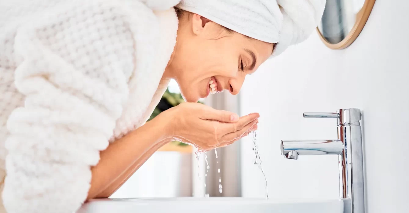 woman washes her face after PRP microneedling