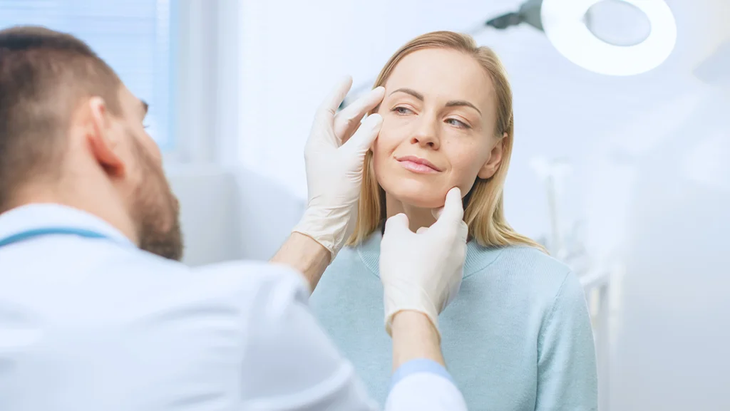 Cosmetic Surgeon Examines Beautiful Woman's Face