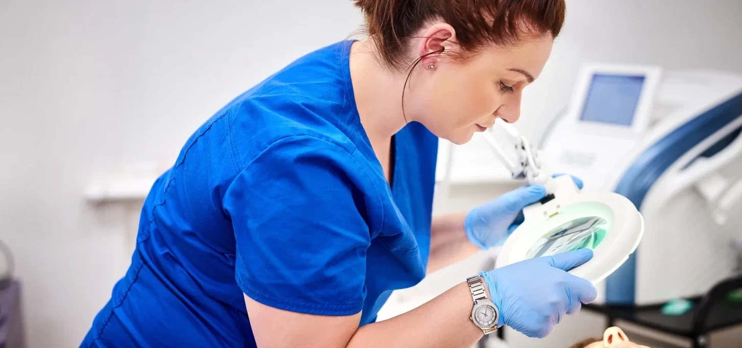 a nurse performs a laser treatment on her client