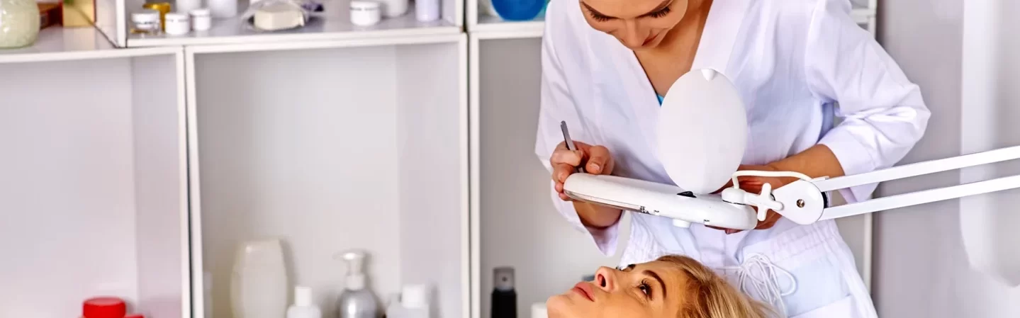 Woman middle-aged lying in spa clinic with a standing Esthetician.