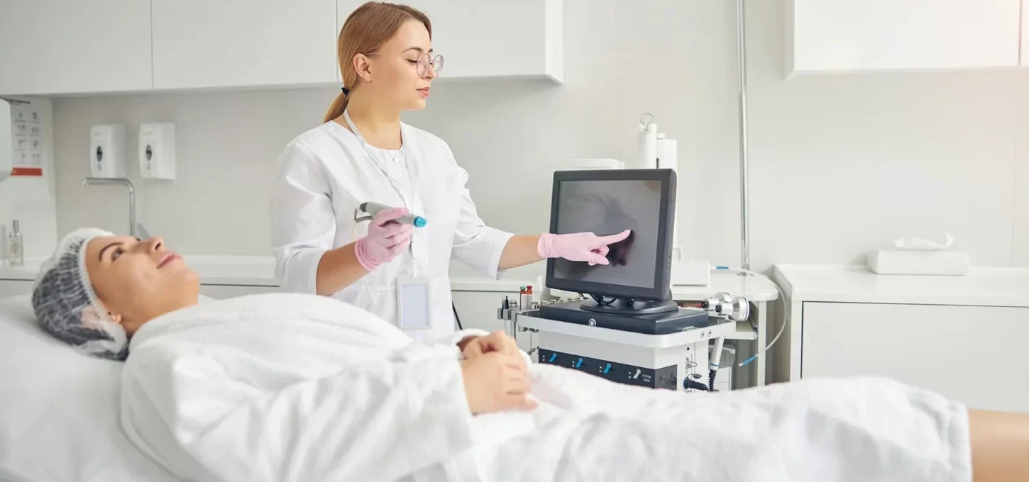 Medical esthetician prepares the equipment for Hydrafacial treatment on her client