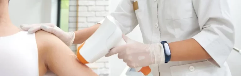 Esthetician working on removing hair using modern laser apparatus in modern equipped spa clinic