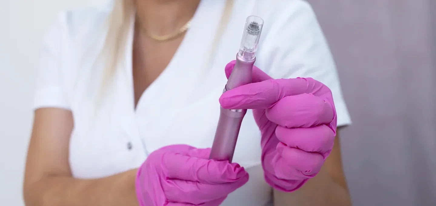 a med spa provider holding a microneedling pen before the procedure