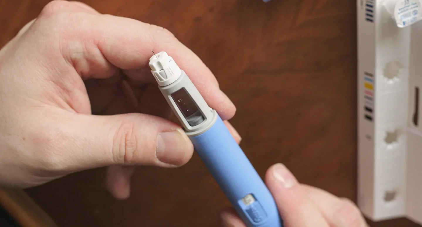 a man checking semaglutide pen dosage