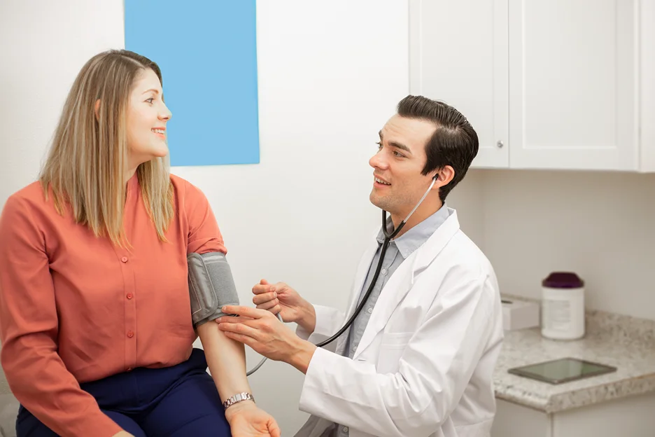 medical professional checking patient's blood pressure