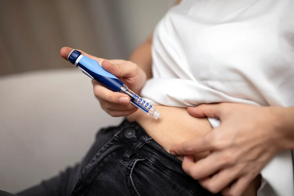 a woman self-injects medication