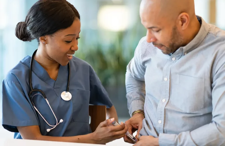 a nurse assists a male patient in administering tirzepatide injection