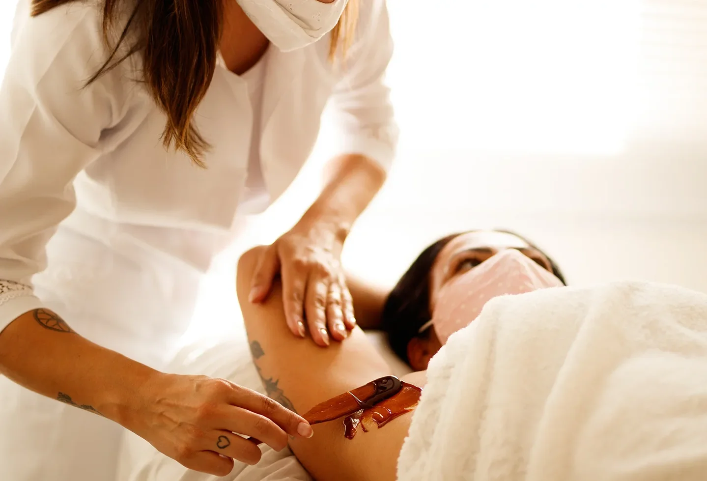 esthetician performs wax procedure