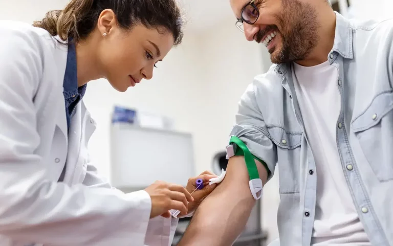 a doctor uses straight needle to draw blood