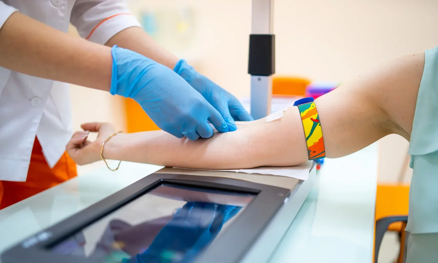 a nurse insserts butterfly needle on the patient's vein