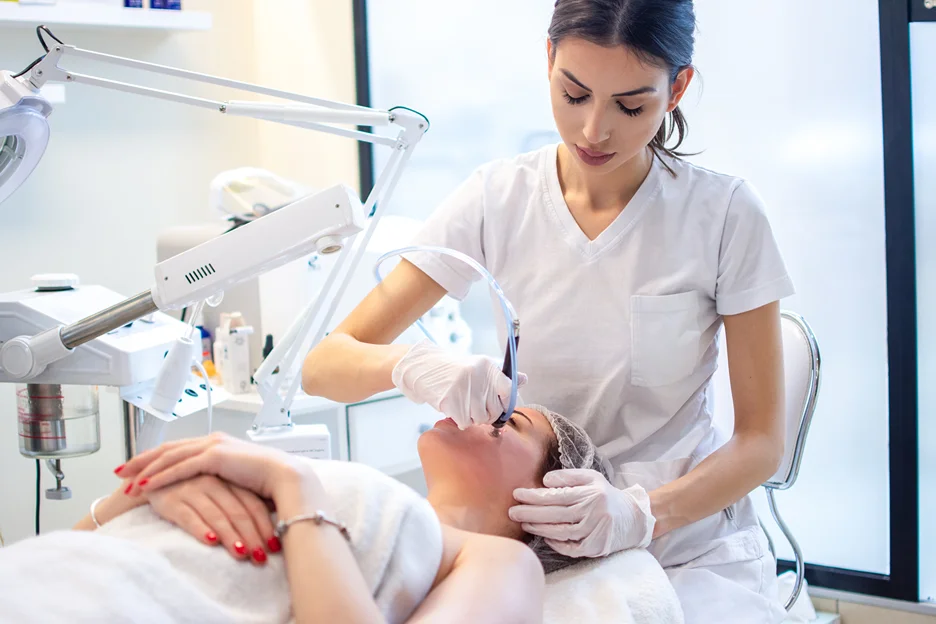 esthetician performs hydrafacial treatment