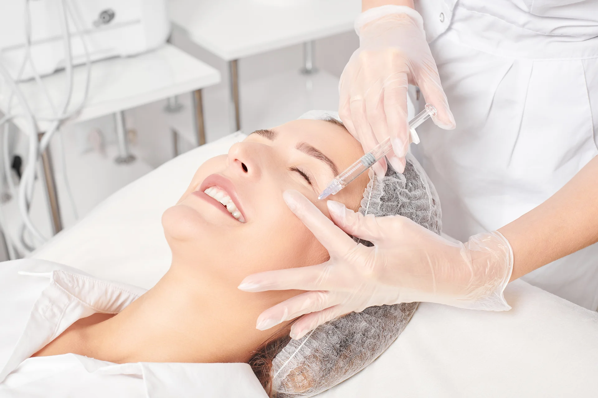 esthetician performs Botox injections on her client