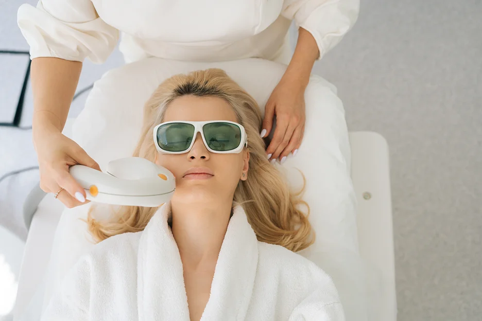 a woman undergoes laser treatment procedure