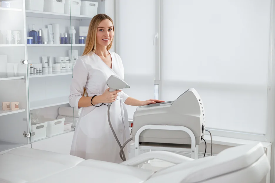 esthetician checks her laser machine