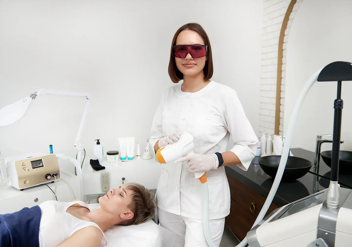 esthetician performs laser treatment