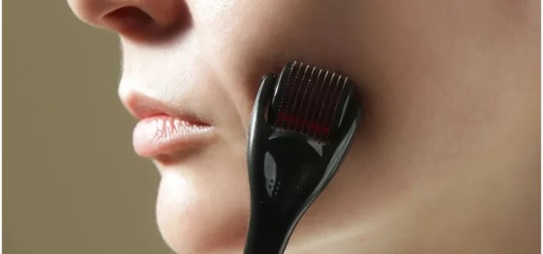 a woman uses derma roller on her face