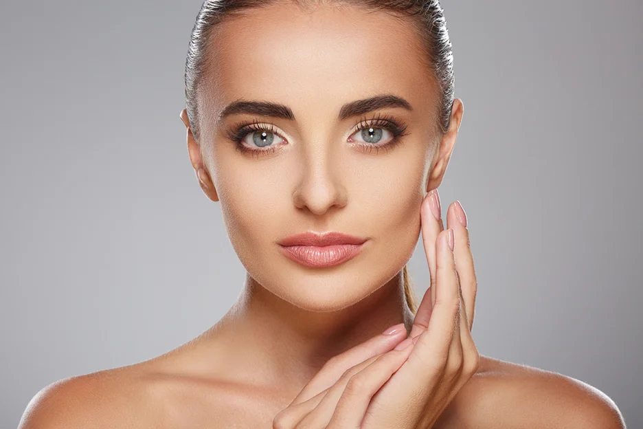 a portrait of a woman touching her smooth skin after salmon dna serum application