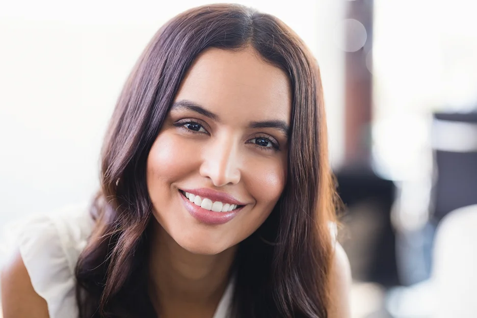 a portrait of a smiling woman with smooth skin after using pdrn skincare