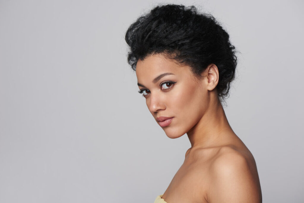 Beauty closeup profile portrait of beautiful mixed race caucasian - african american woman looking at camera