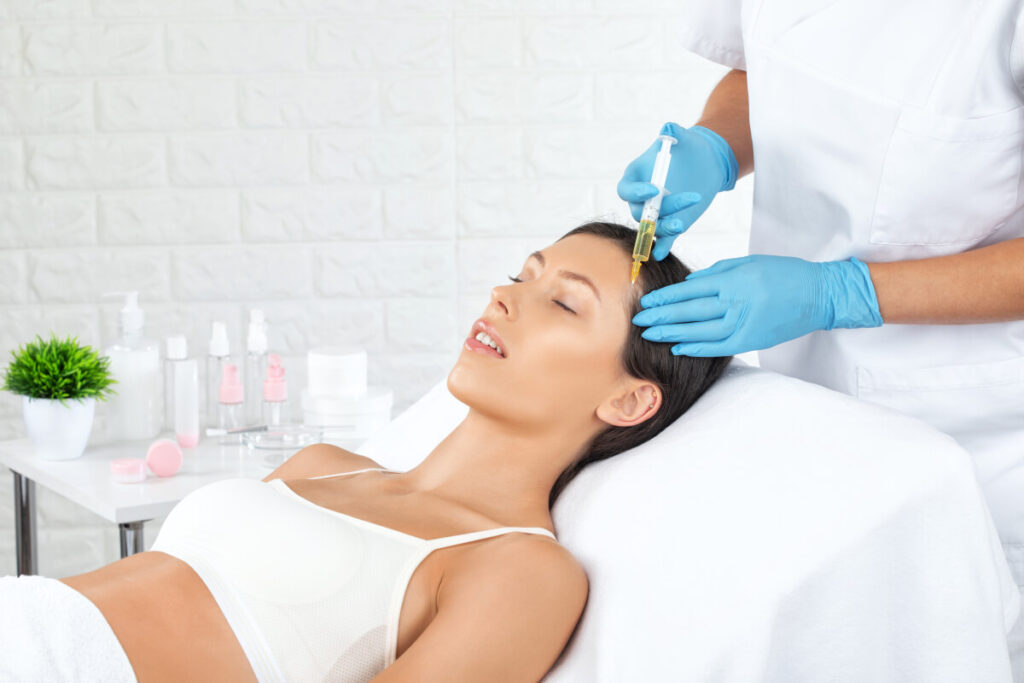 Cosmetologist does prp therapy of a beautiful woman