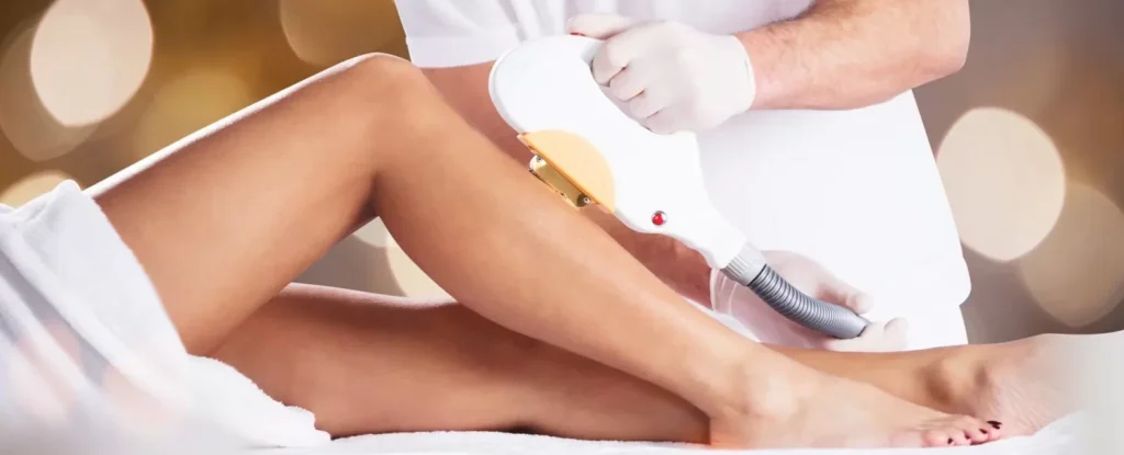 a medical provider performing laser hair removal on a woman's leg